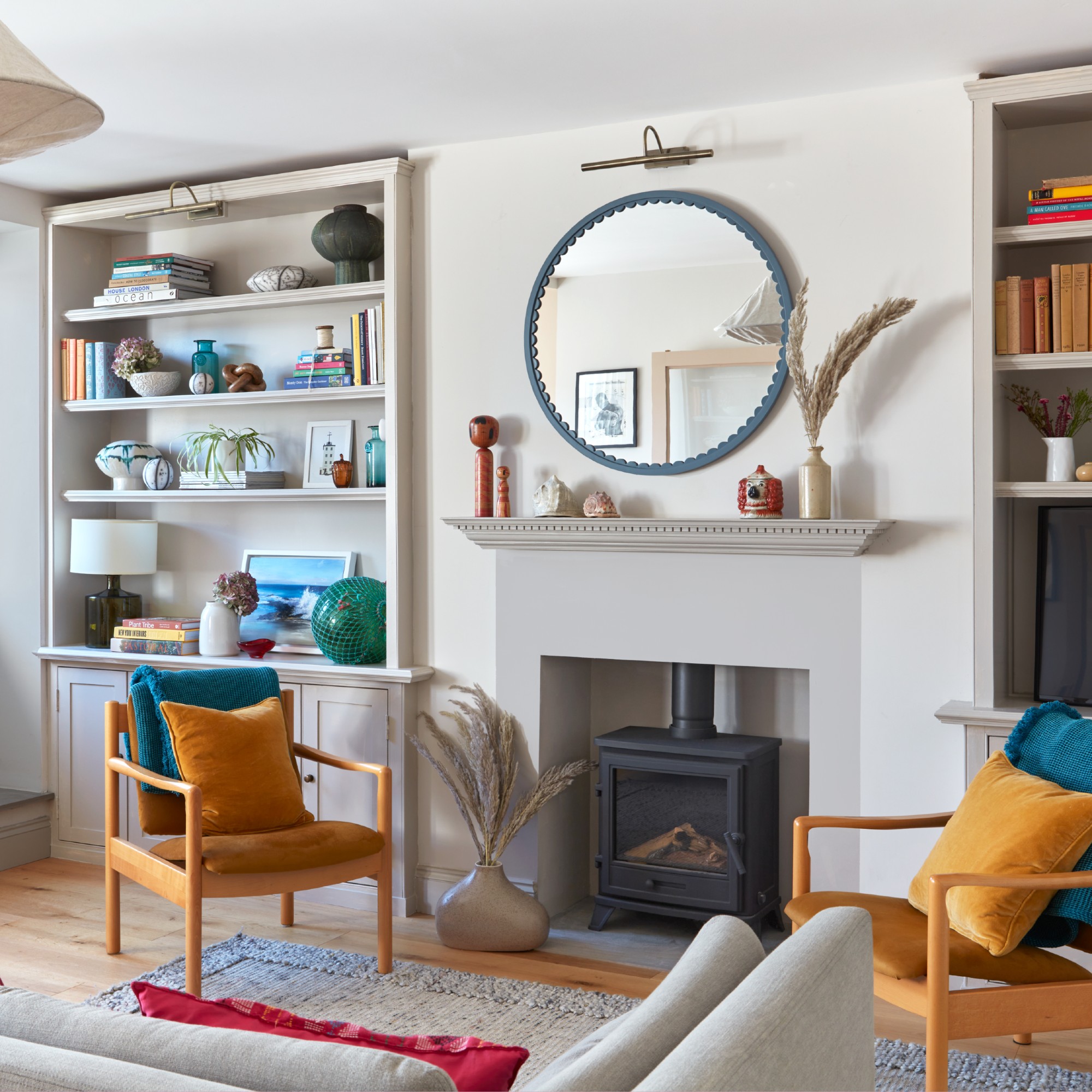 A living room with the surround of a fireplace painted grey