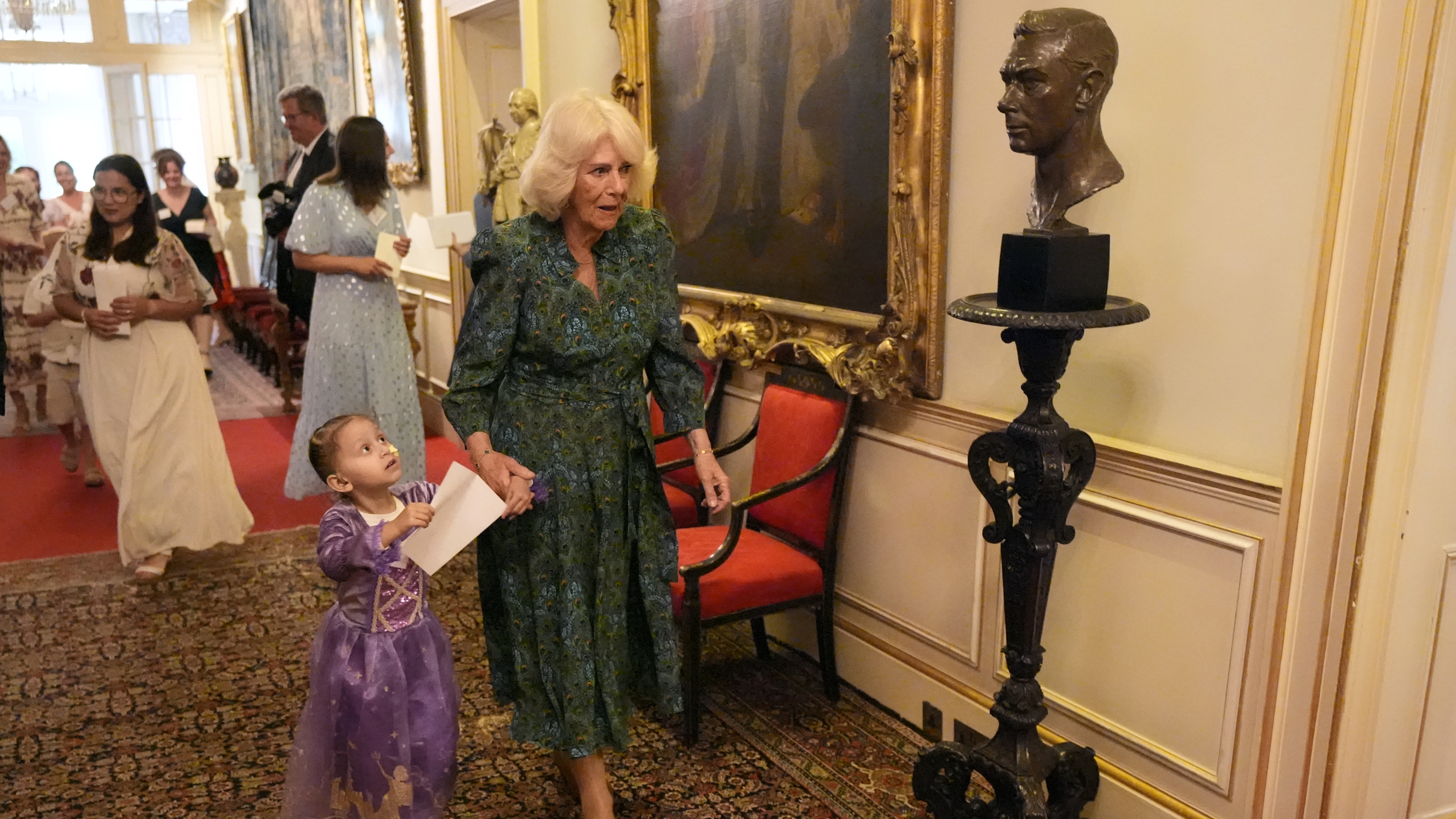 Queen Camilla helps children in a treasure hunt as she hosts a tea party and treasure hunt for children supported by Dreams and Wishes