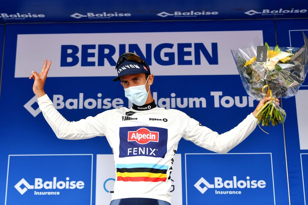 BERINGEN BELGIUM JUNE 19 Dries De Bondt of Belgium and Team AlpecinFenix celebrates winning the white most combative rider jersey on the podium ceremony after the 91st Baloise Belgium Tour 2022 Stage 5 a 1799km stage from Gingelom to Beringen BaloiseBelgiumTour on June 19 2022 in Beringen Belgium Photo by Luc ClaessenGetty Images