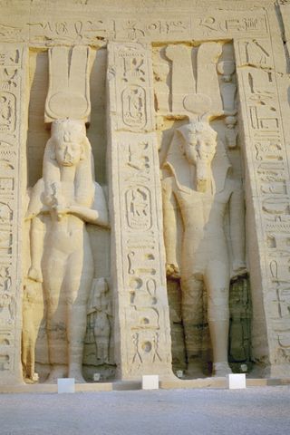 A statue of Queen Nefertari (left) at the rock temple Abu Simbel, dedicated in her honor. Her statue is the same size as her husband's (right), indicating her elevated status.
