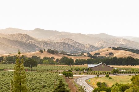 The S&eacute;ka Hills tasting room set amid a landscape of olive groves, fields and the Blue Hills