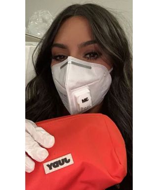 Kim Kardashian wearing 3M mask and holding Judy product