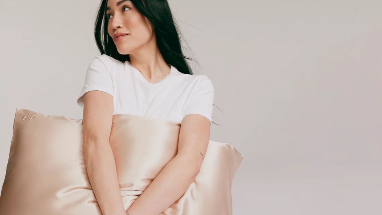 woman holding one of the best silk pillowcases