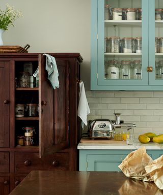 antique pantry cupboard in a blue devol kitchen