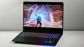 HP Omen Max 16 open on a white desk at an angle.