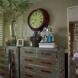 bedroom with chest of drawers and clock on wall
