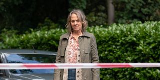 Niamh Cusack as Claire Mills looking at red police tape.