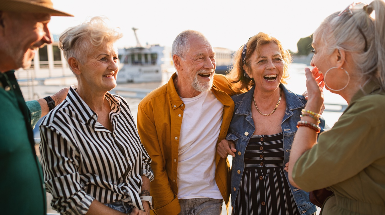 Front view of cheerful men and women travellers laughing.
