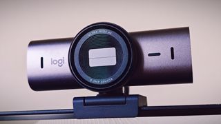 A Graphite-coloured Logitech MX Brio webcam sitting on top of a monitor