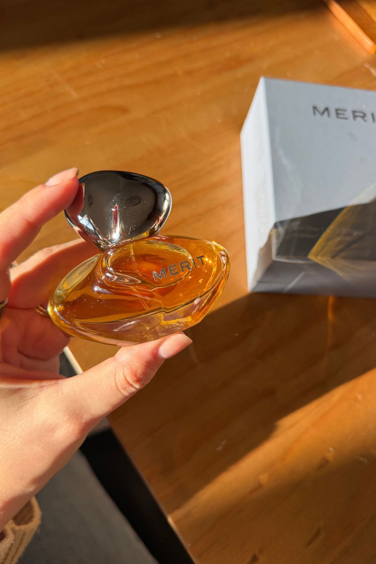 Shannon Lawlor holding Merit New Wave perfume