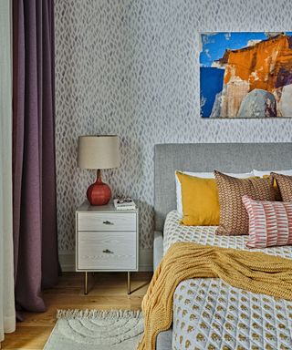 Grey headboard, wooden bedside table