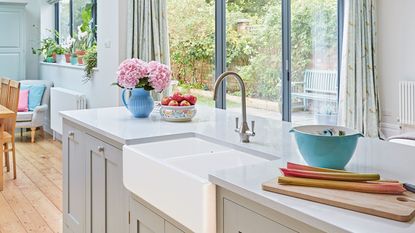 Kitchen Window With Shelves And A Traditional Sink Tap And Running