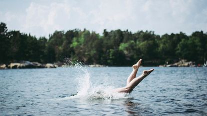 person diving into a lake