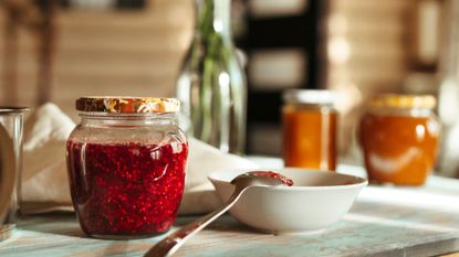 Pot of homemade raspberry jam on a countertop, used to illustrate a woman&home piece on the most common jam mistakes