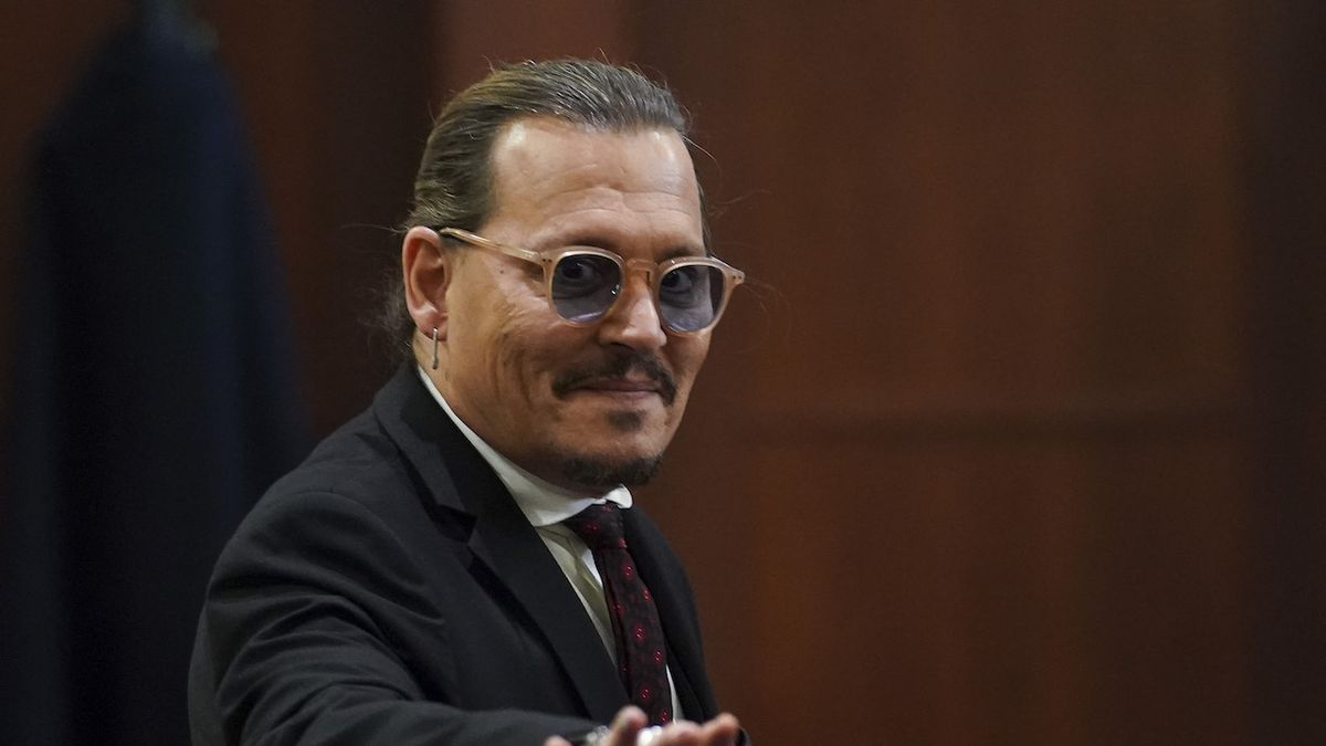 Johnny Depp smiling in court during the trial against Amber Heard