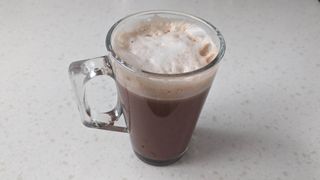 Latte in a tall glass cup