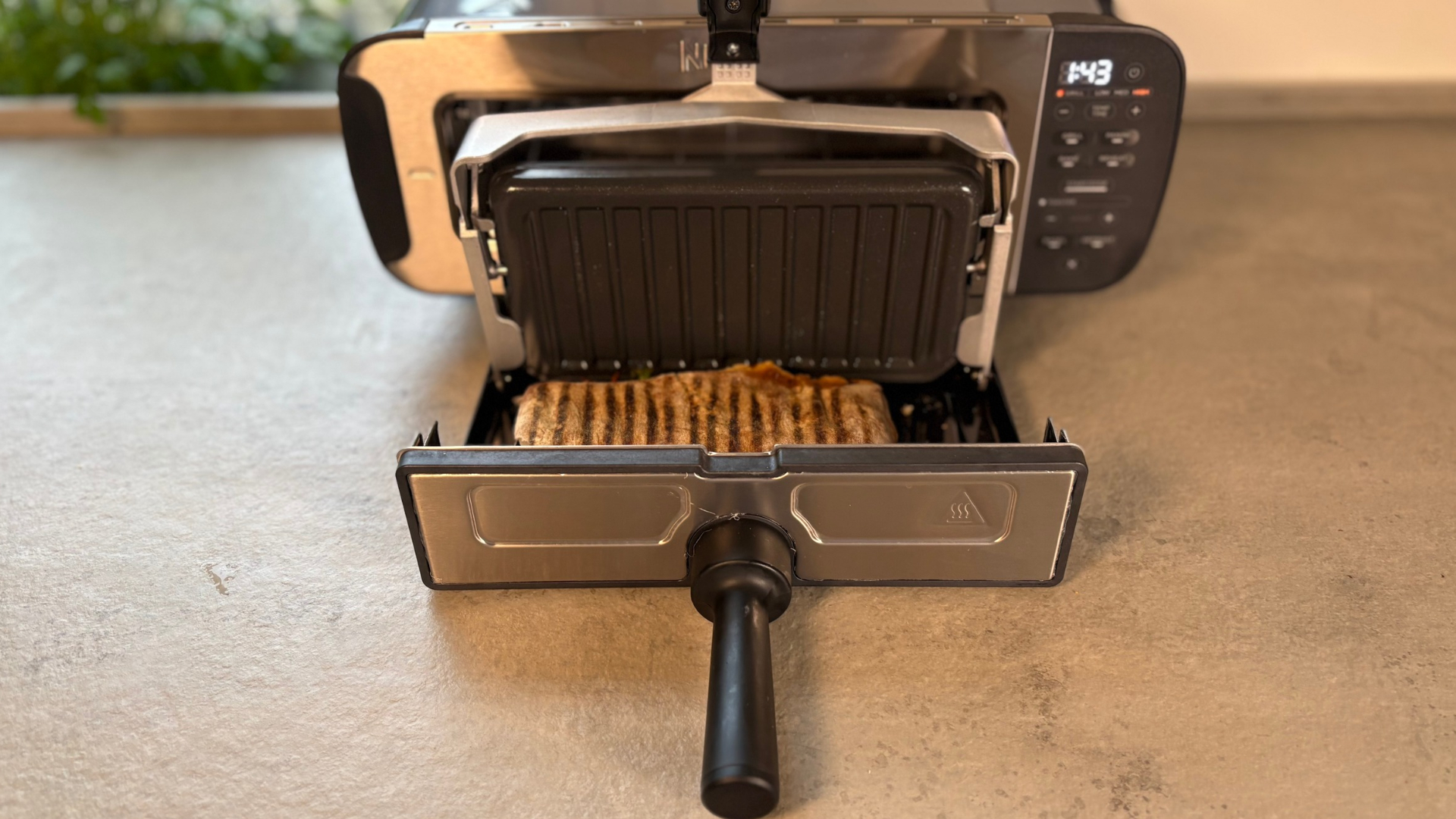 Testing the Ninja Foodi 3-in-1 Toaster Grill Panini Press on the counter making a panini
