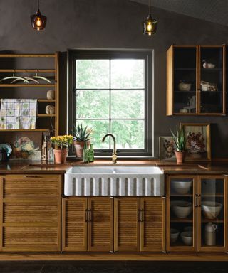 wood cabinets, fluted sink, chocolate brown walls, open shelving, wall unit, glazed lower cabinets, glass pendant lights,