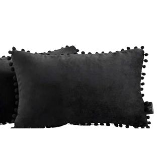 Two black rectangular pillows with pom pom trims