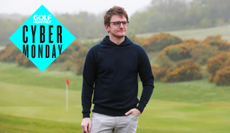 A golfer poses in Sun Day Red, with a Cyber Monday badge in the corner