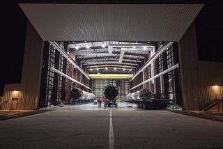 Long shot of SpaceX’s three landed Falcon 9 first stages, taken from outside a hangar at Kennedy Space Center’s Launch Complex 39A on May 14, 2016.
