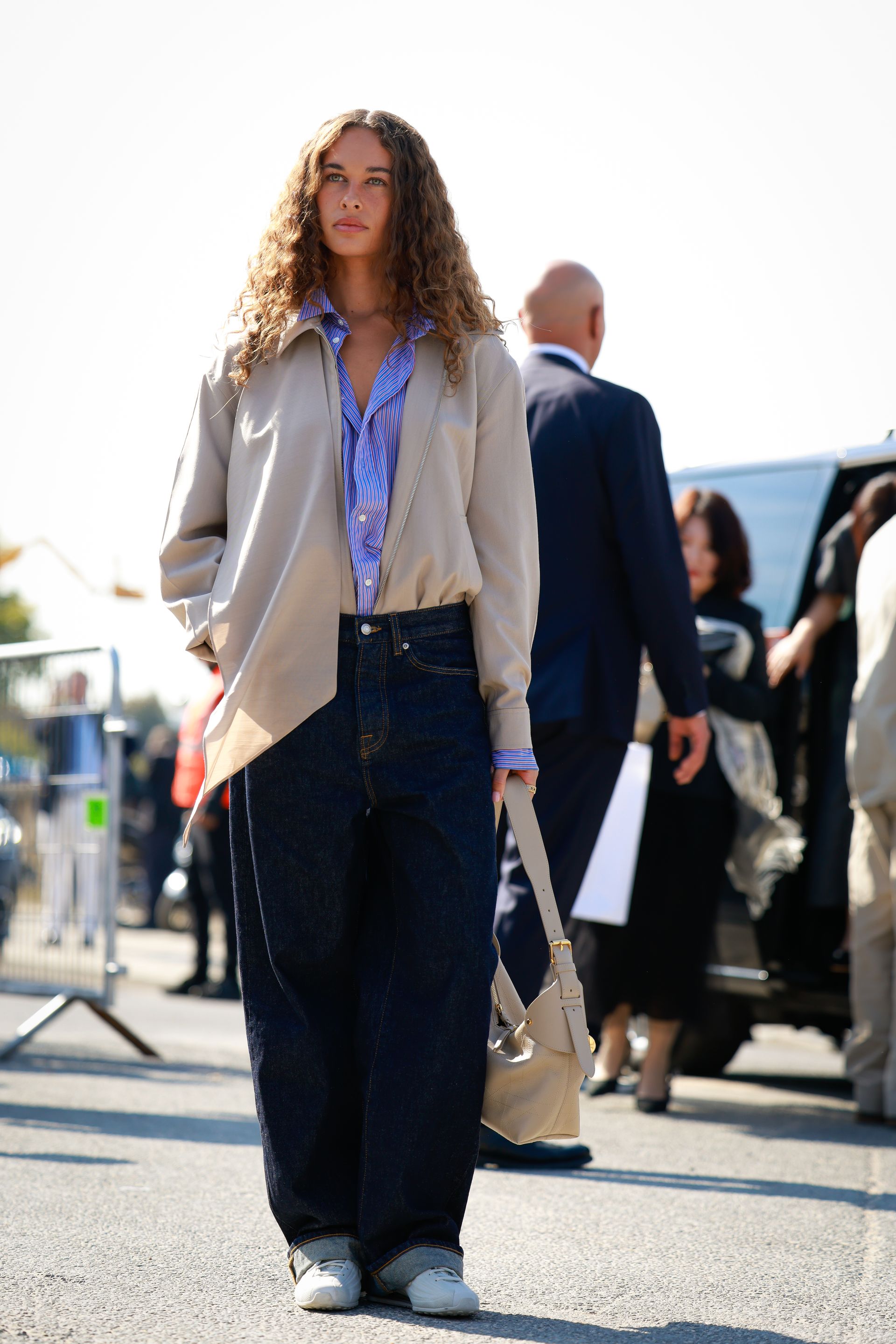 Fashion person Sarah Lysander is seen wearing baggy jeans. She pairs them with a blue shirt, beige jacket, white trainers and beige bag outside Christian Dior during the Womenswear Spring Summer 2026 as part of Paris Fashion Week on October 01, 2025 in Paris, France.