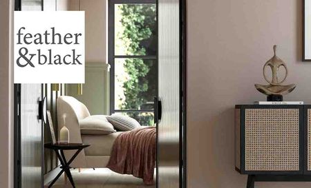 Feather and Black logo placed over an image of a bedroom