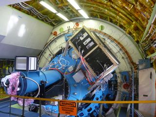 A close-up of two SOFIA science instruments, FLITECAM and HIPO, which are connected to the telescope on the other side of the bulkhead. Science instruments can be removed and swapped out between flights; the plane usually flies with just one instrument aboard.