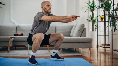 A man performing a bodyweight squat