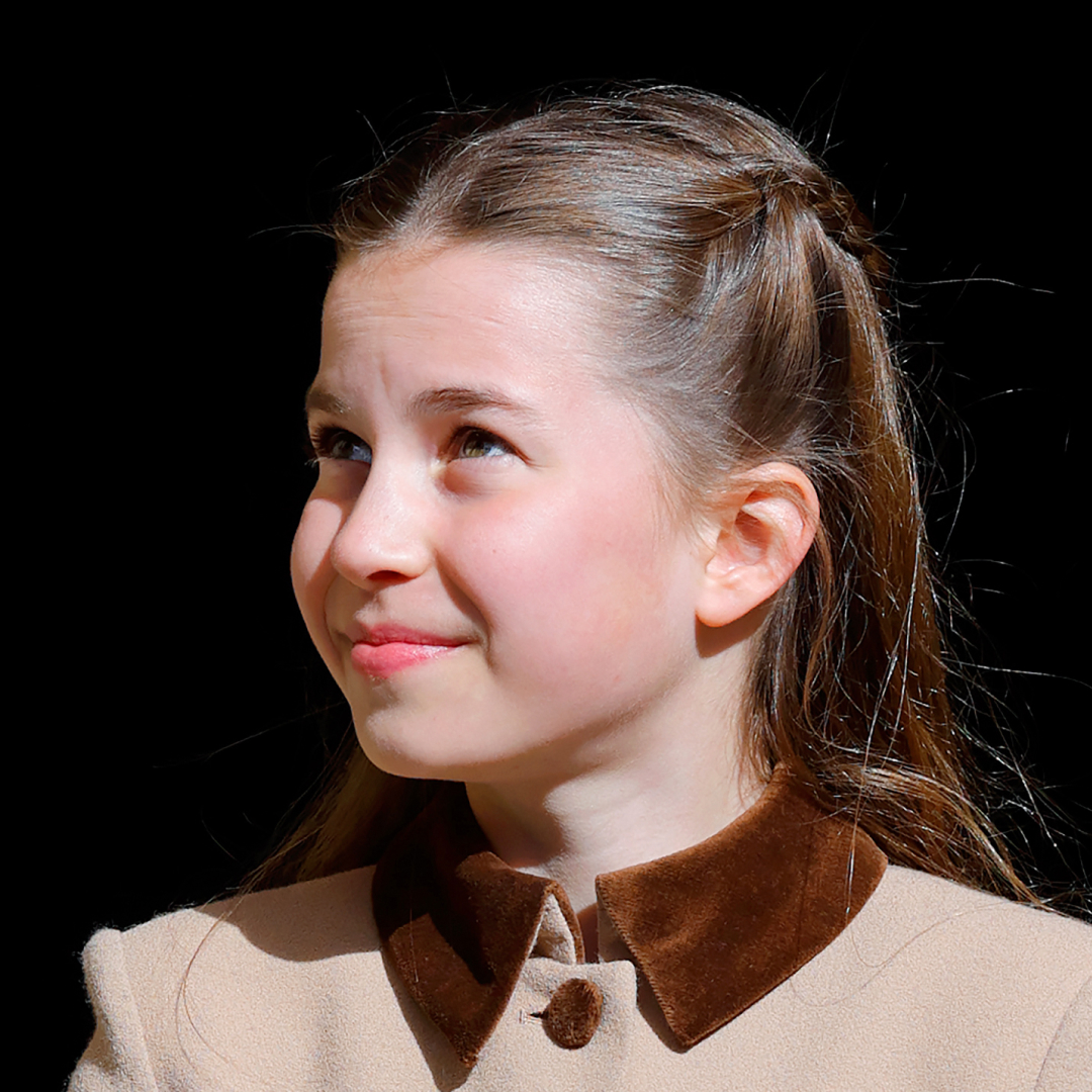 Princess Charlotte wearing a brown coat and smiling