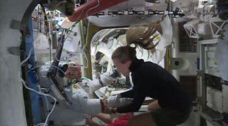 Astronaut Parmitano (left) re-entered the International Space Station following cancellation of a spacewalk on July 16, 2013, owing to water floating inside his helmet.