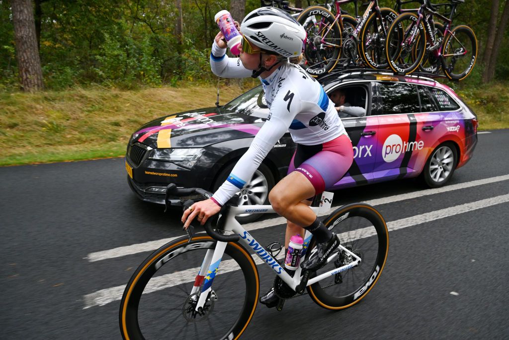 ARNHEM NETHERLANDS OCTOBER 13 Lorena Wiebes of The Netherlands and Team SD Worx Protime assisted by the team car during the 26th Simac Ladies Tour 2024 Stage 6 a 1458km stage from Arnhem to Arnhem UCIWWT on October 13 2024 in Arnhem Netherlands Photo by Luc ClaessenGetty Images