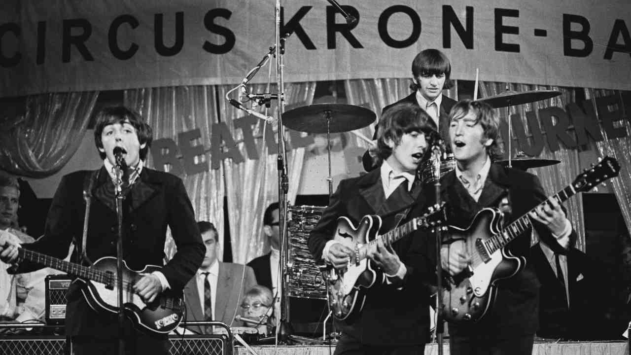 The Beatles performing onstage in 1966