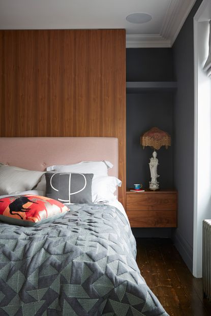 Grey bedroom with wooden headboard