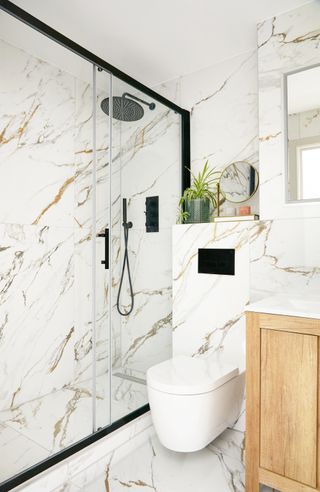 A marble shower room with matt black brassware