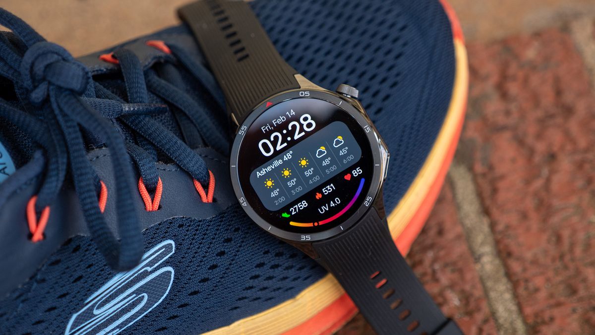 A OnePlus Watch 3 with a fitness watch face on a pair of workout shoes