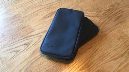 Rapha Rainproof Essentials Case and phone on a wooden table 