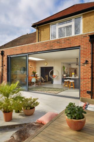 Dani Ellis home: full width extension with indoor-outdoor link, sliding doors and matching floor tiles