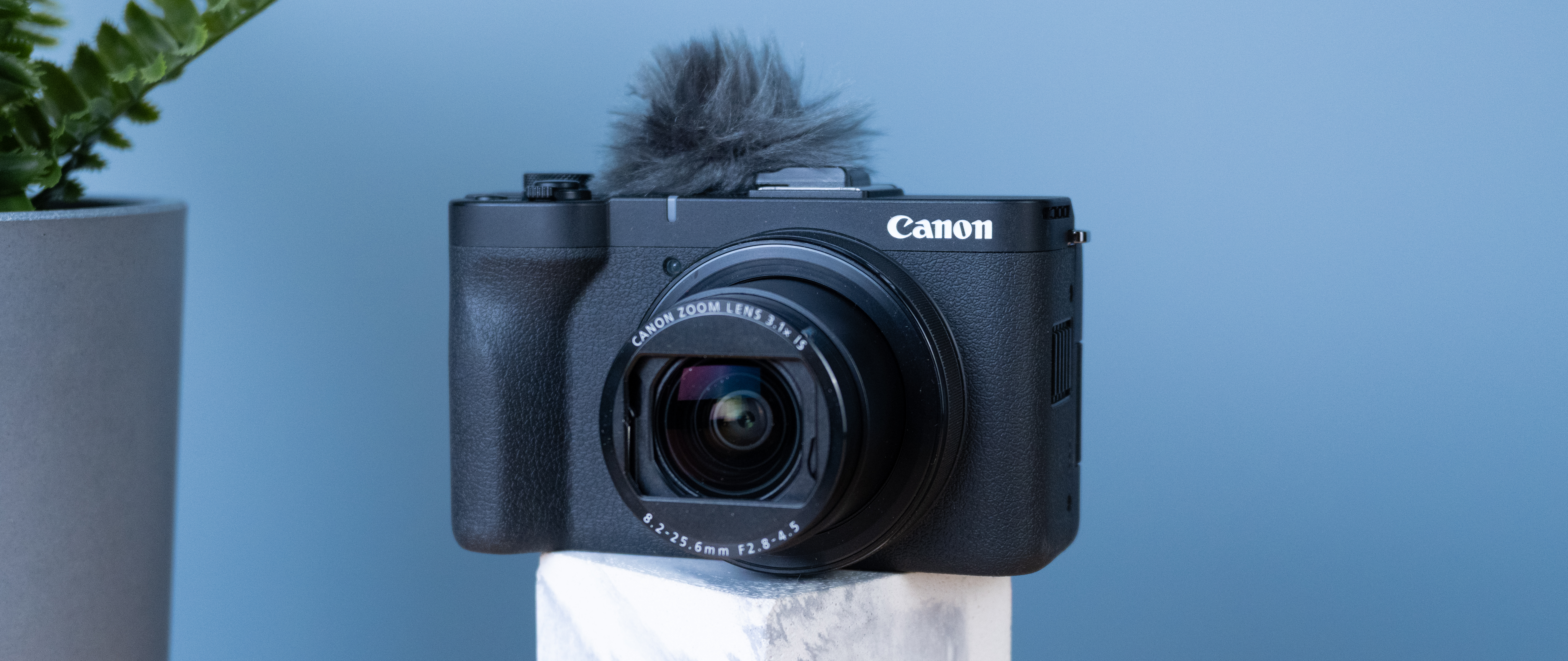 A black Canon PowerShot V1 compact vlogging camera