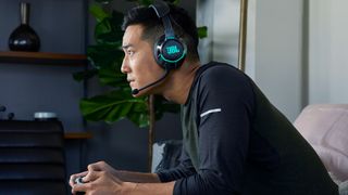 man gaming with jbl quantum headset