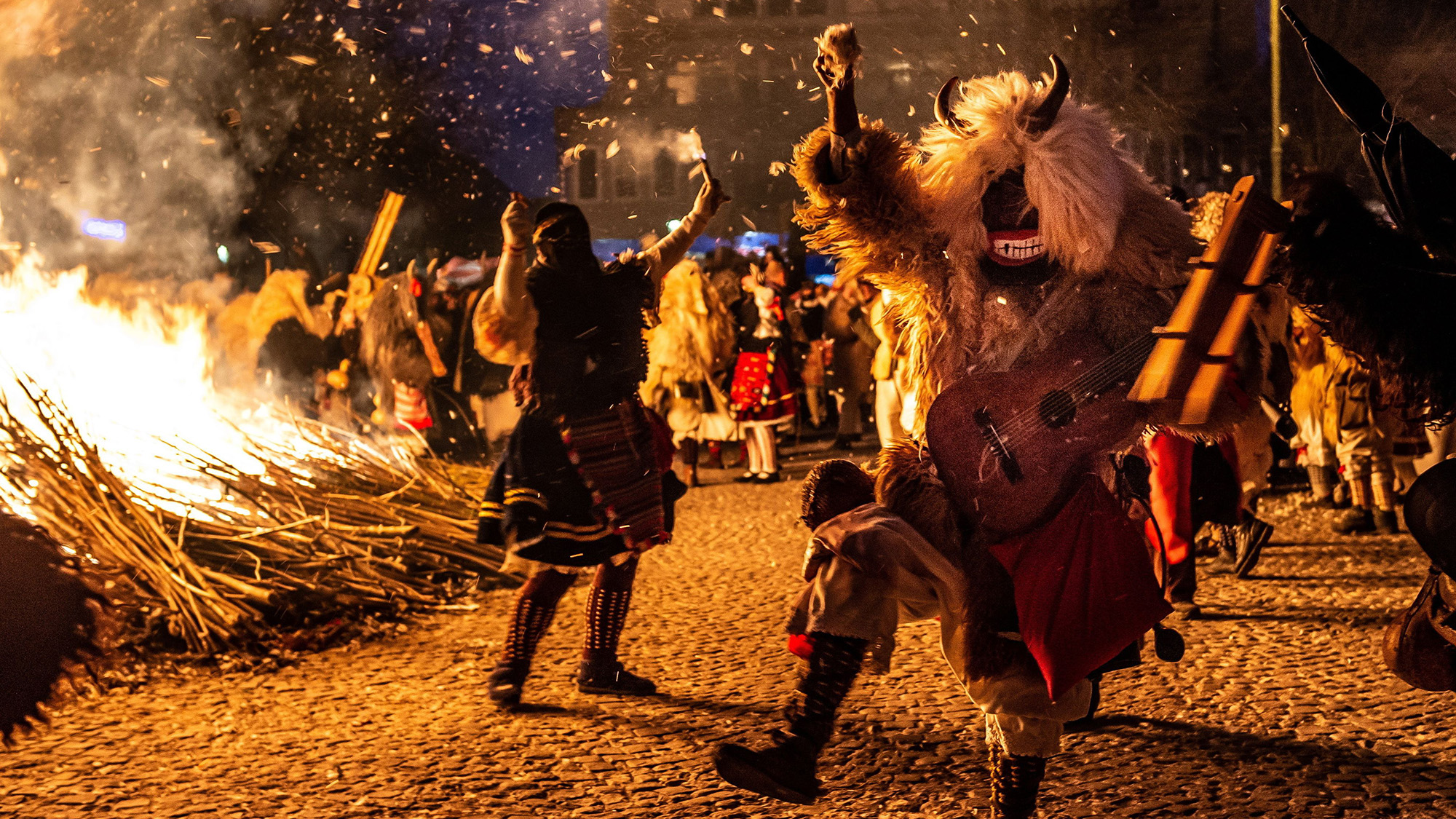 Costumed revelers dance around a bonfire during the festival which marks the end of winter in Mohacs, Hungary