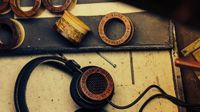 Grado headphones on a worktop with various driver housings