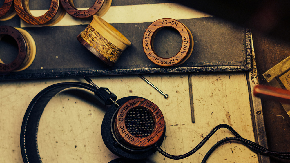 Grado headphones on a worktop with various driver housings