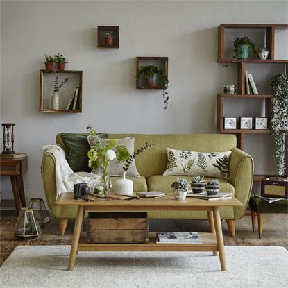 living area with sofa and plant wall 
