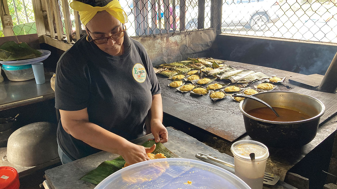 A woman preparing food at El Bur&amp;eacute;n de Lula, Puerto Rico