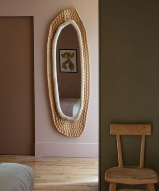 A bespoke textured mirror in a green and pink room