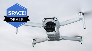 A Ruko F11PRO 2 drone against a cloudy sky. 