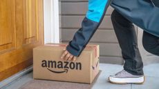 A man places Amazon delivery box on front porch 