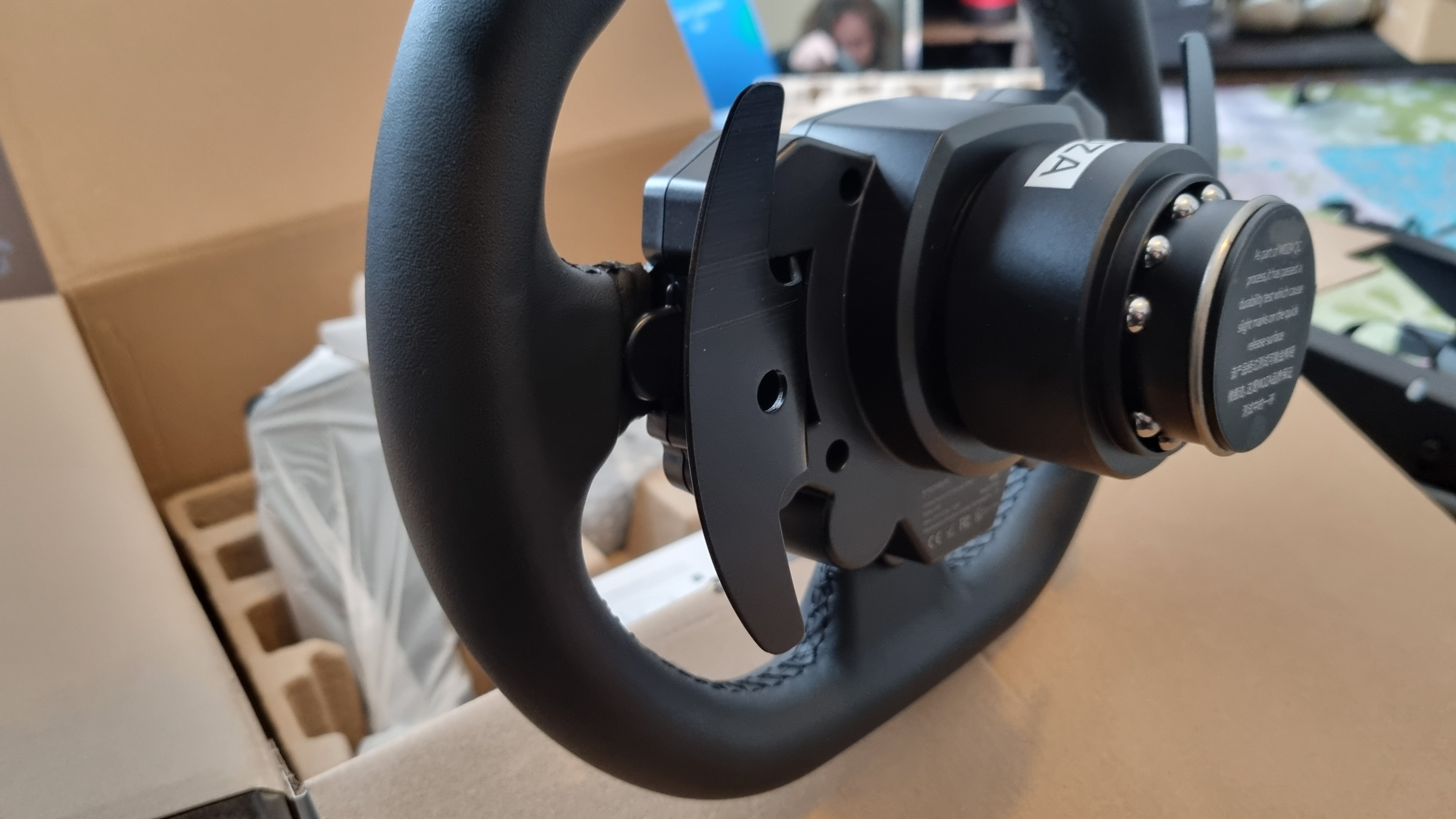 The rear of the MOZA R5 ES steering wheel, showing the magnetic shifter paddles