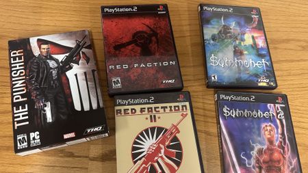A photo shows a collection of physical Volition releases that belonged to the developer